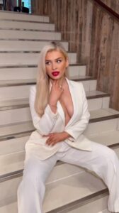 Love Island's Liberty Poole flaunts her braless figure in a daringly plunging white suit
