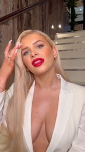 Love Island's Liberty Poole flaunts her braless figure in a daringly plunging white suit