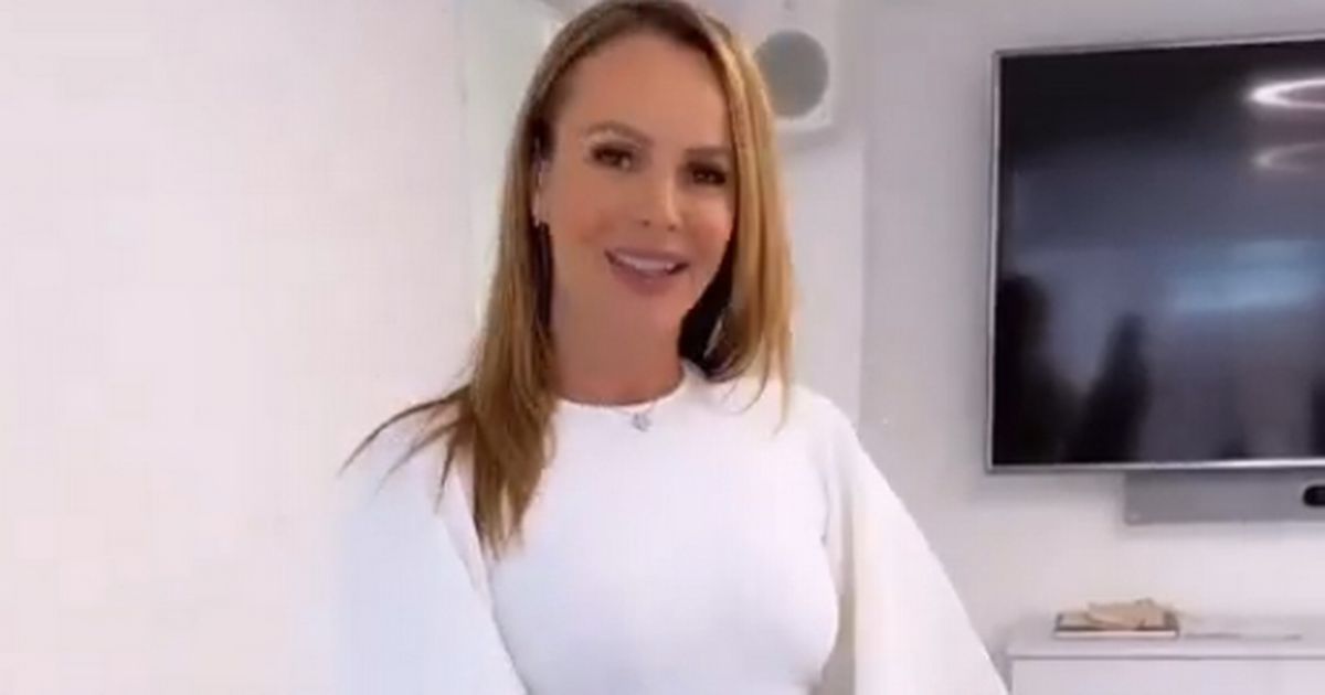 Amanda Holden, dressed in white and sporting a "cheeky" split, likes to think of herself as a "nice girl"