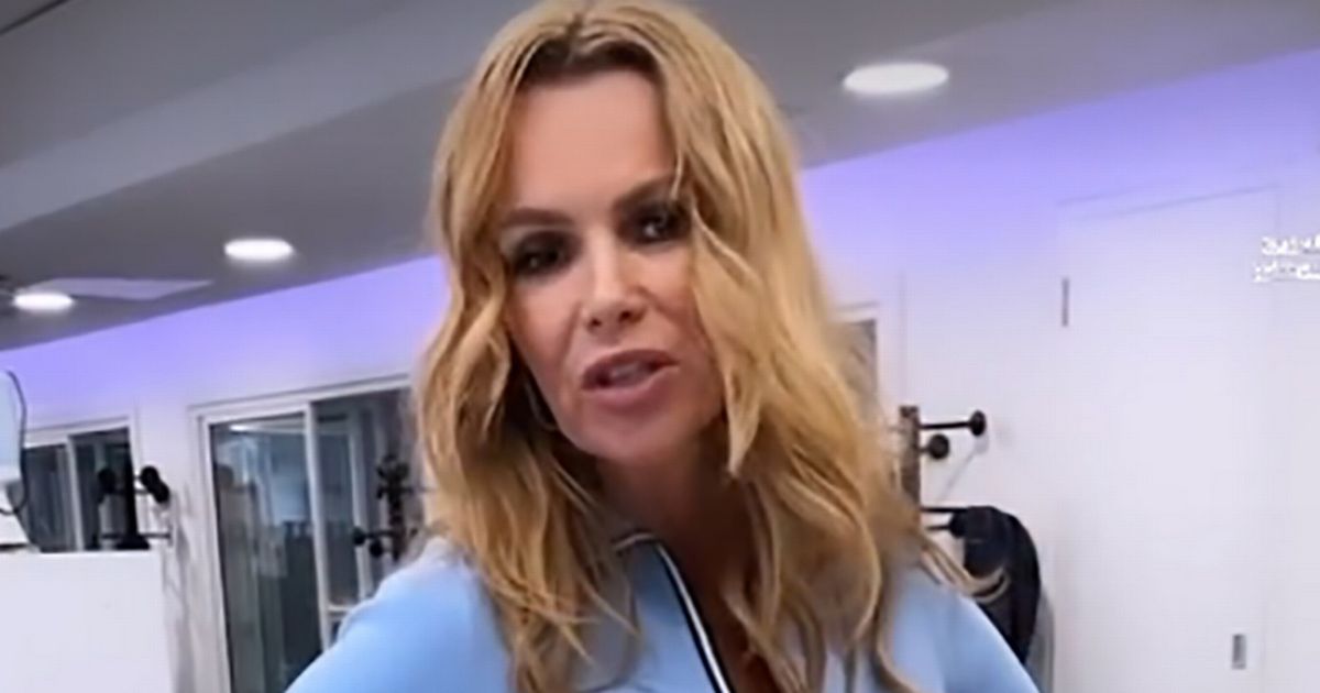 Amanda Holden, 52, strips down to a crop top while running for hot office video on Heart FM