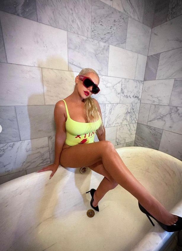 Christina Aguilera wears a customized yellow swimsuit