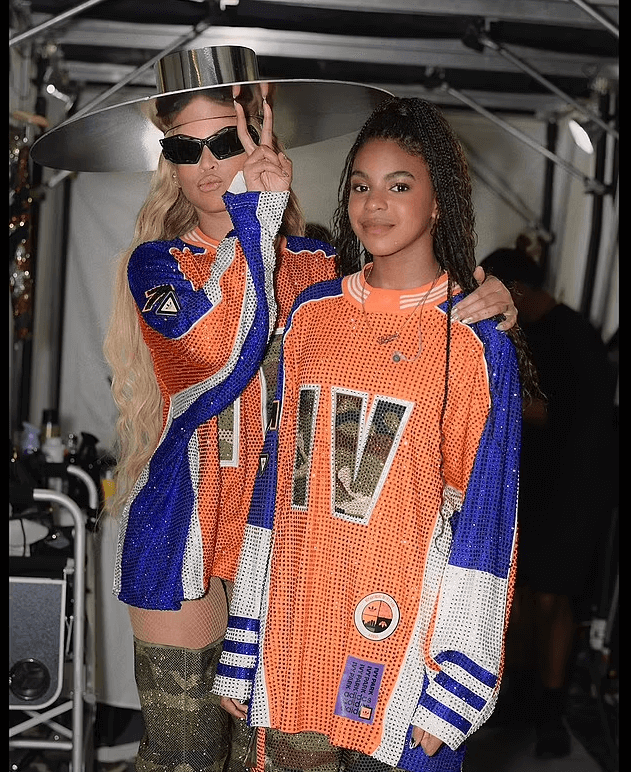 Beyonce wore an orange-and-blue football jersey that had been covered in sequins in her first set of snaps in which she was accompanied by her daughter Blue Ivy.