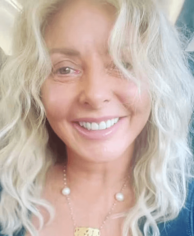 Carol Vorderman showed off her radiant complexion with no makeup and left her long curly blonde tresses loose as she went on a train to London.