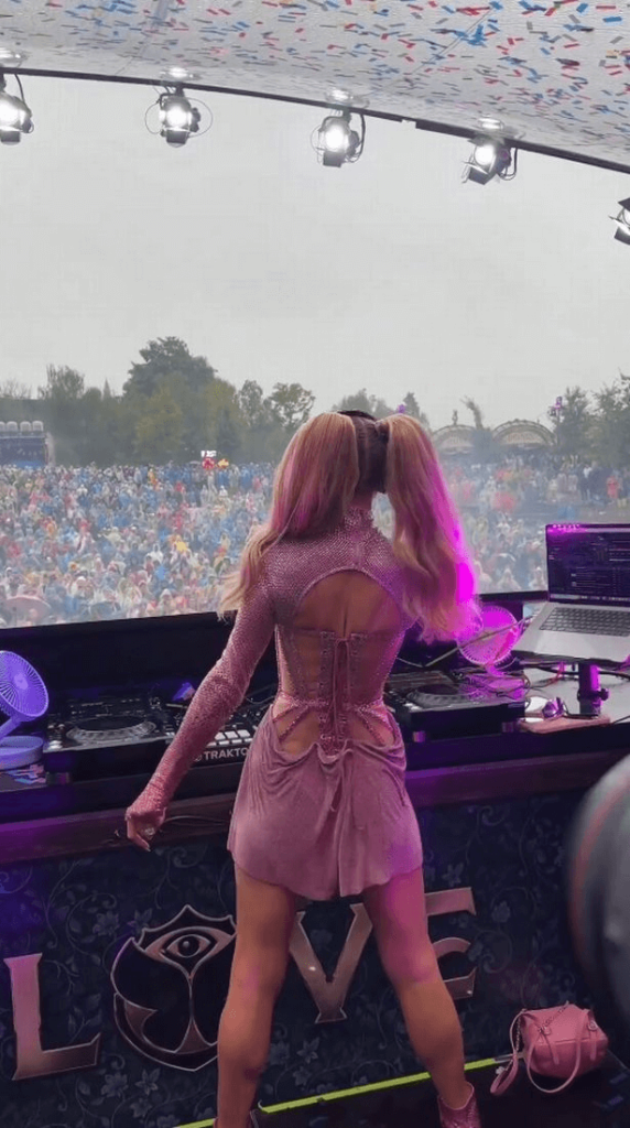 Paris Hilton recently posted a video of herself DJing at Tomorrowland in a pink minidress with cut out sections around her midriff and a revealing neckline.
