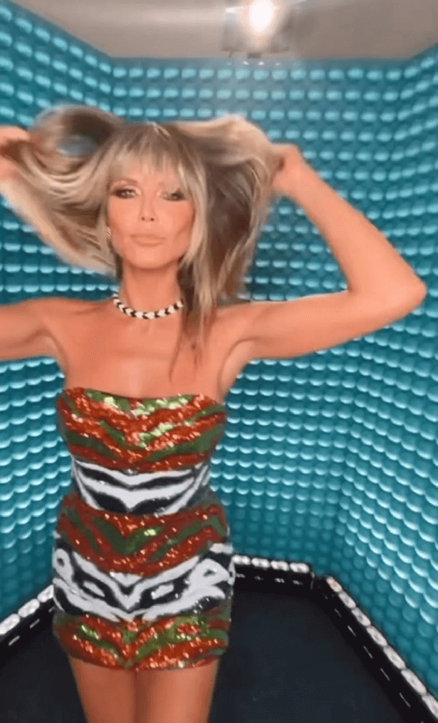 She wore a barely-there glitter dress with black and white zebra print alternating with green and red sparkles.