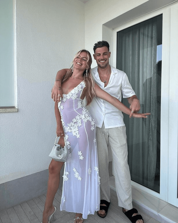 Another photo shows the couple dressed to impress, with Andrew wearing a crisp white shirt and beige linen trousers to stay cool.