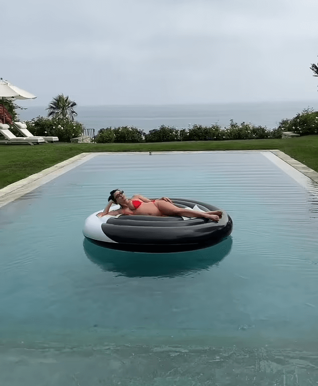 Kourtney Kardashian was generous with her pictures as she posed like a Vogue model by a set of stairs and floated in the pool.