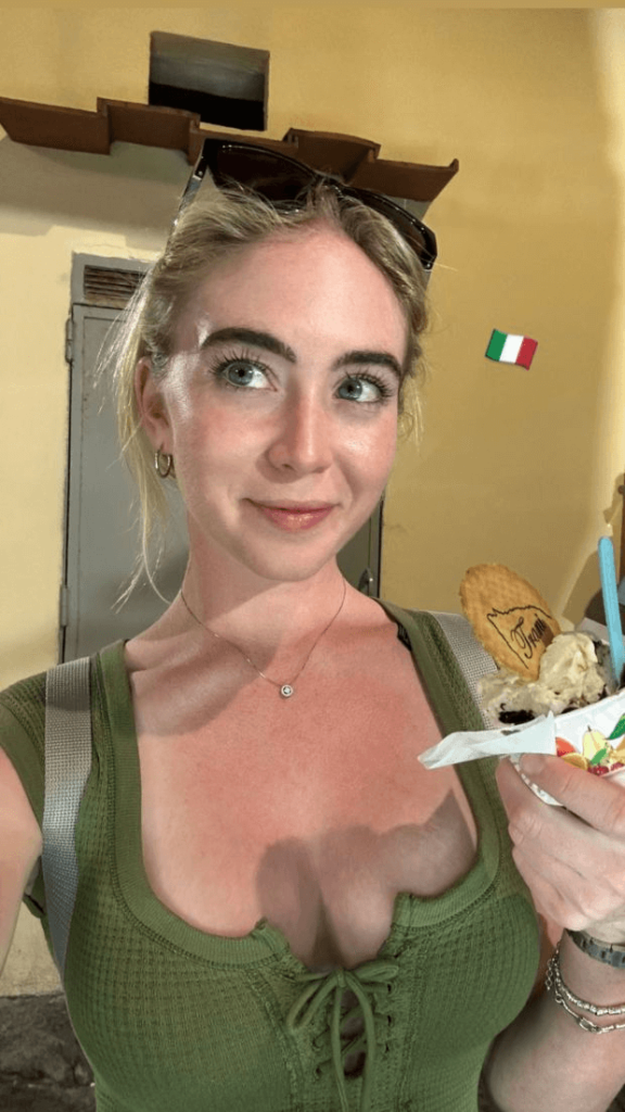 In an Italy vacation snap, Grace Charis wears a revealing top while eating ice cream

