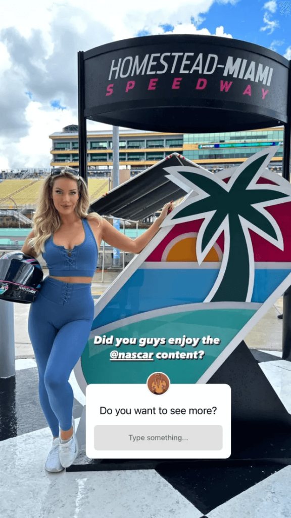Paige posed alongside a car at the Homestead Speedway Nascar race in a plunging blue top.