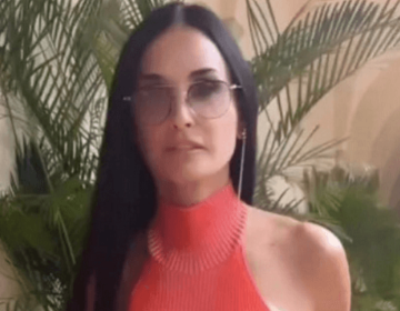 In a see-through red dress, Demi Moore displays ageless figure without a bra