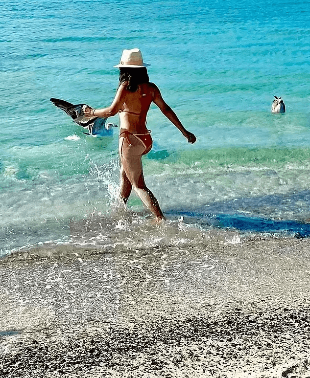 She soaked up the sun at the beach while celebrating her 57th birthday in a red string bikini.
