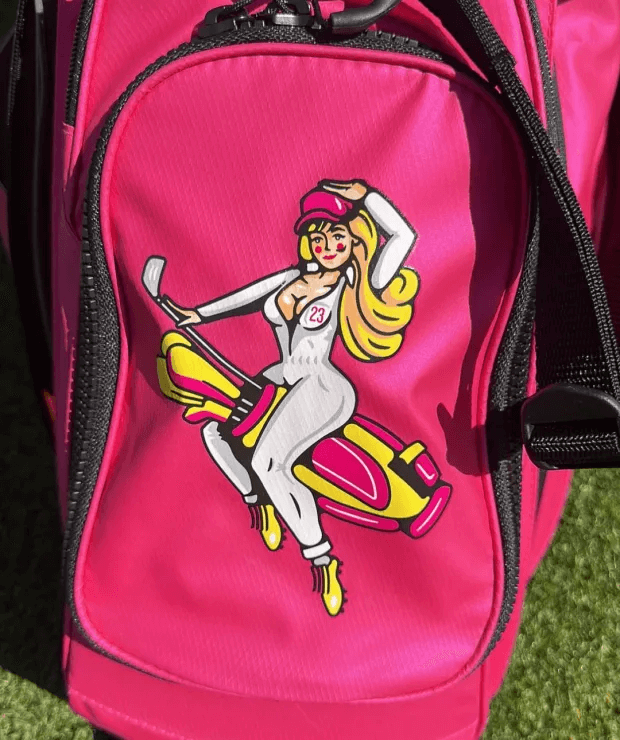 A cartoon was emblazoned on the front pocket of her pink golf bag.