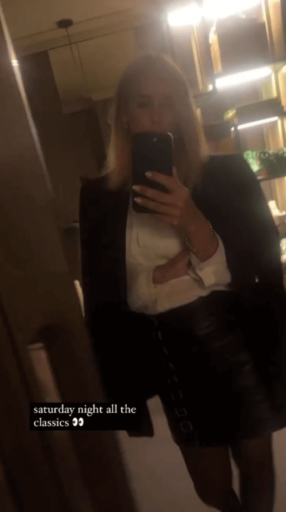 Her Instagram fans saw Louise wearing a white silk shirt and black leather skirt as she walked towards her full-length mirror.