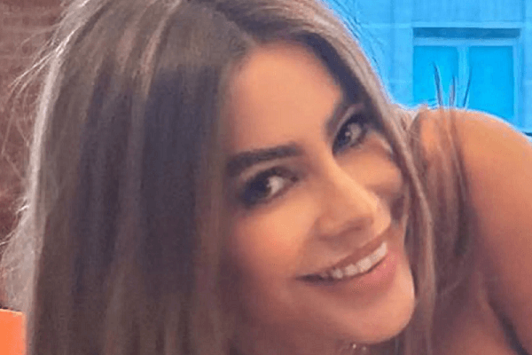 A tight top risked a wardrobe malfunction on Sofia Vergara as she topples over the couch in her hotel room