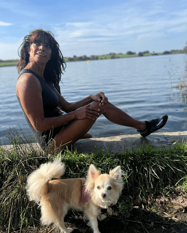 In her tight grey swimsuit, Jenny Powell plunges into a lake for a daring dip in the water