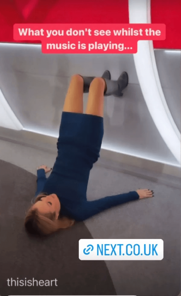 Amanda posted the video showing her hip thrusts while laying on the floor with her legs pushing up on the wall. Amanda wore a navy mini dress with knee-high black boots.