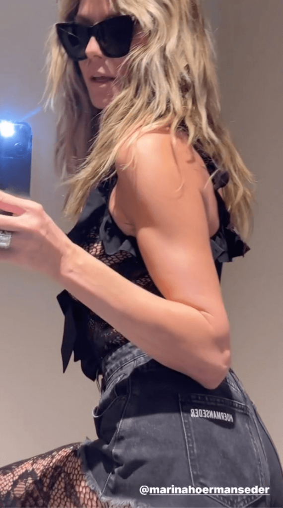 Heidi Klum snapped a cheeky zoomed-in selfie while in the bathroom wearing lace tights and short shorts.