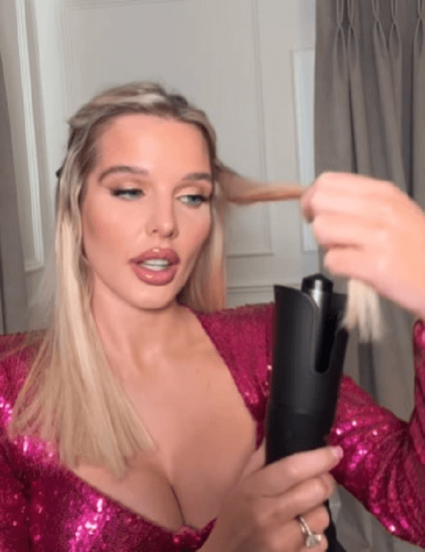 In the video, Helen Flanagan, 33, glammed up in a plunging sparkly pink dress to film a hair transformation clip promoting a new curling iron.