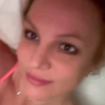 A steamy new video shows Britney Spears posing in bed in her new Victoria’s Secret push-up bra