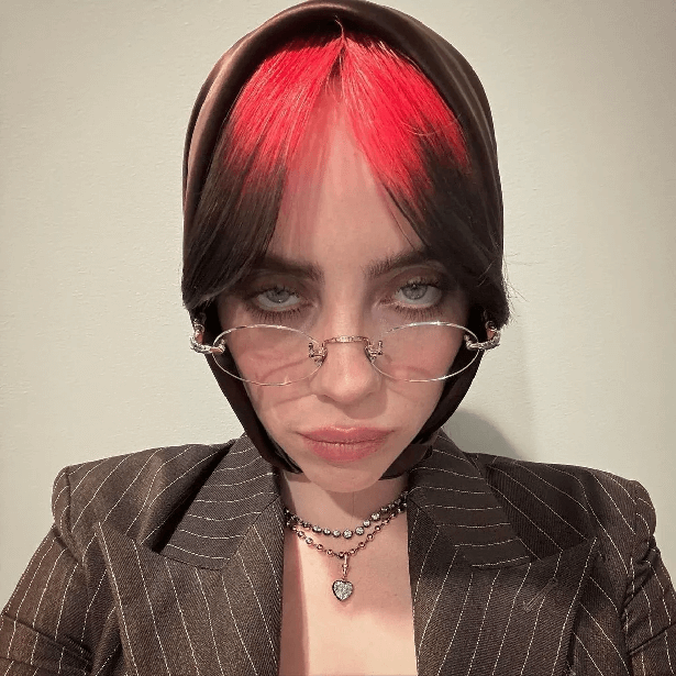 In a plunging blazer, Billie Eilish displayed her incredible curves as she posed for selfies with a silk scarf around her hair.