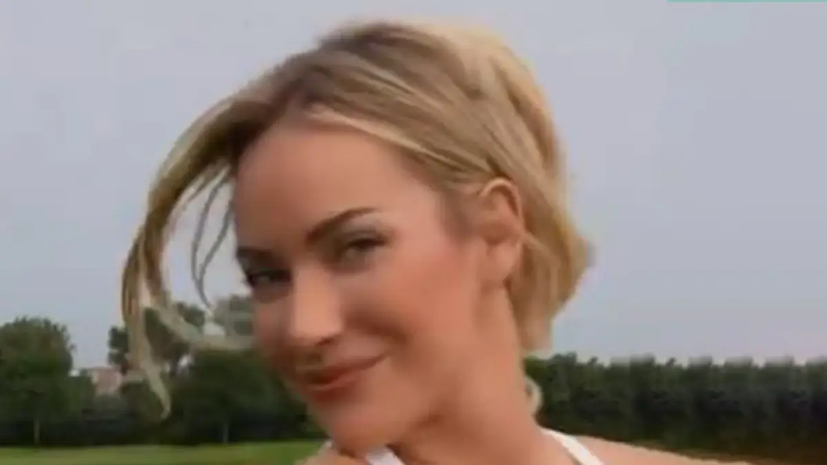 Paige Spiranac wore a low-cut white minidress and kept focused on the ball while teaching putting