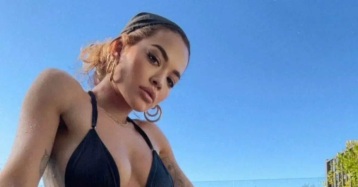Rita Ora shows off her bum in a miniscule black bikini as she posed for a series of stunning photos
