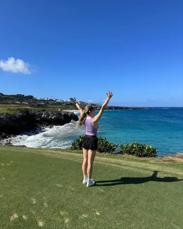 In numerous videos and pictures, Grace wore a small purple top with black shorts at a golf course in Hawaii.