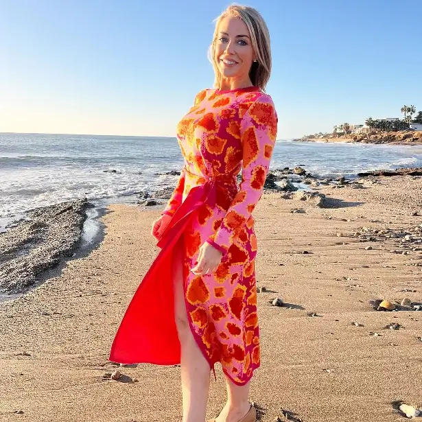 On a windy day in Spain, Laura Hamilton looked fabulous in a red thigh-split dress as she exposed her legs.