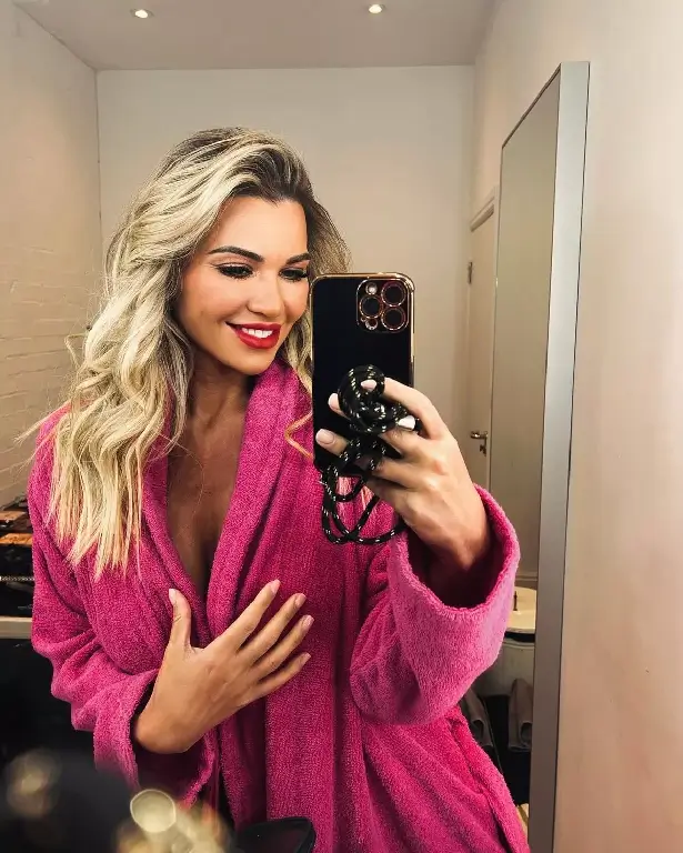 In a racy bathroom pic, Christine McGuinness went topless in nothing but a gaping pink robe leaving her followers swooning.