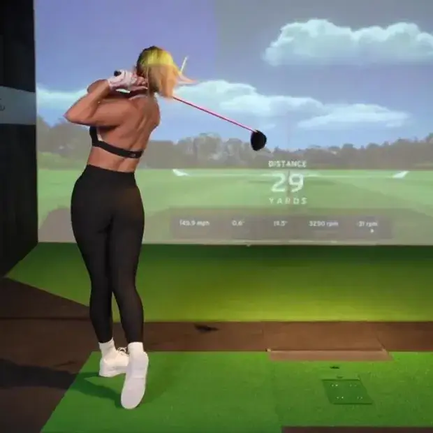 With a tight-fitting black leggings and crop top, Paige Spiranac shows off her incredible golf swing that has fans in a frenzy