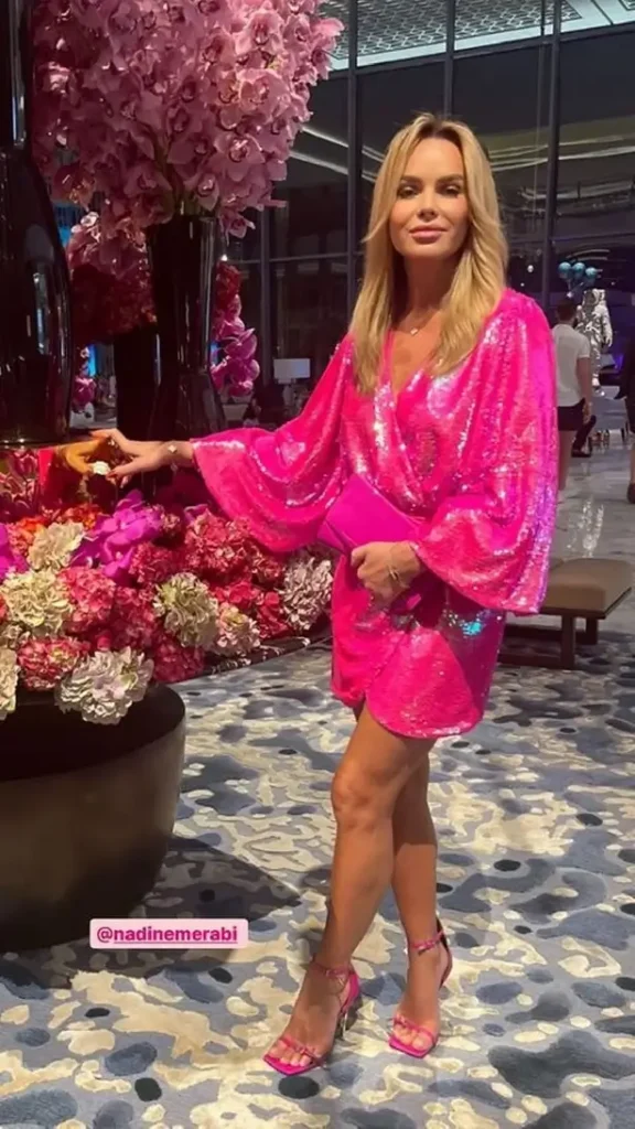 While on vacation in Dubai, Amanda Holden took the spotlight with her latest jaw-dropping outfit - a neon pink minidress.
