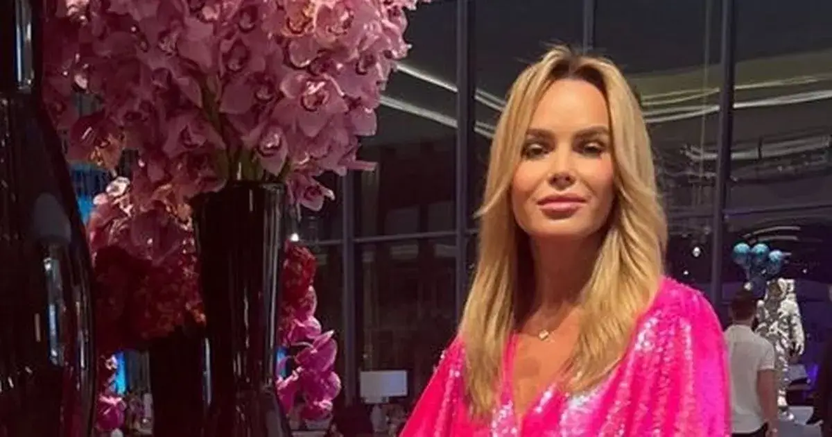 Amanda Holden shows off her killer curves when she put on leggy display in a neon pink minidress