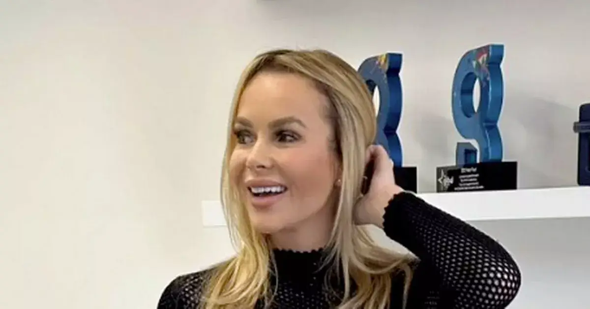 In a ‘naughty’ see-through top, Amanda Holden flashes bra then pulling up skirt and revealing her thighs boots