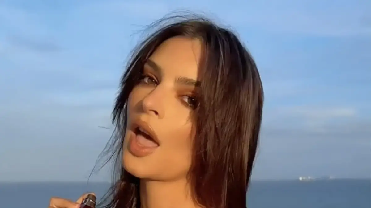 Model Emily Ratajkowski, 33, nearly exposed her bare boobs as she walks on a yacht with a low-cut white dress