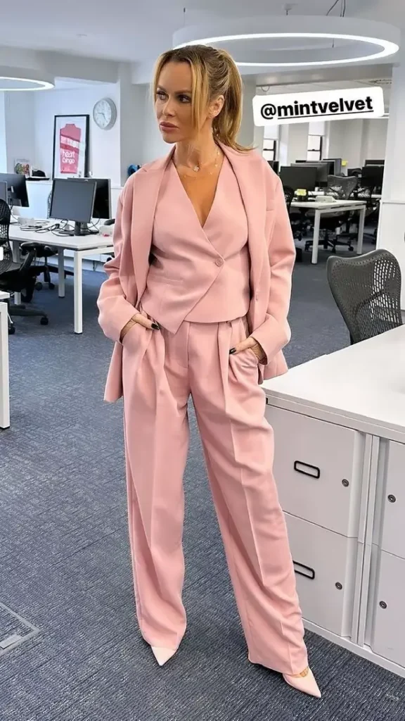 Amanda Holden looked stunning in a plunging low-cut pink suit with a stylish bow from Mint Velvet when she strutted around the Heart FM office.