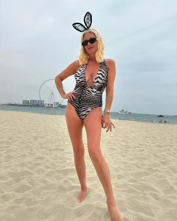 Denise Van Outen posed in a plunging swimsuit and bunny ears to be a racy bunny on the golden sand