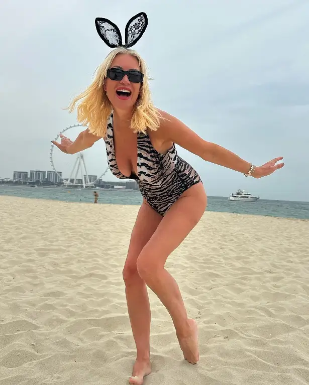 While in Dubai for Easter, Denise Van Outen showed off her stunning physique in a plunging swimsuit and bunny ears.