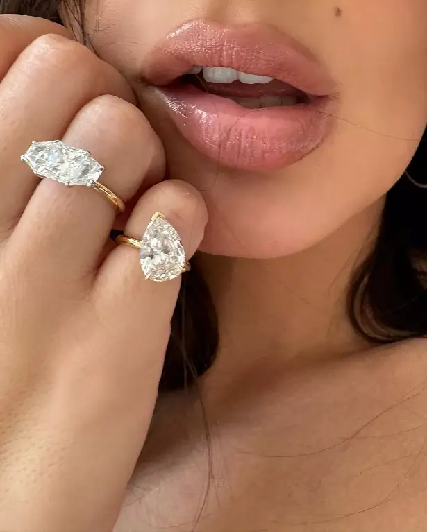 Another picture shows her hoisting the duvet high above her head to show off her silver hoop earrings and glam make-up look, despite still being in bed.