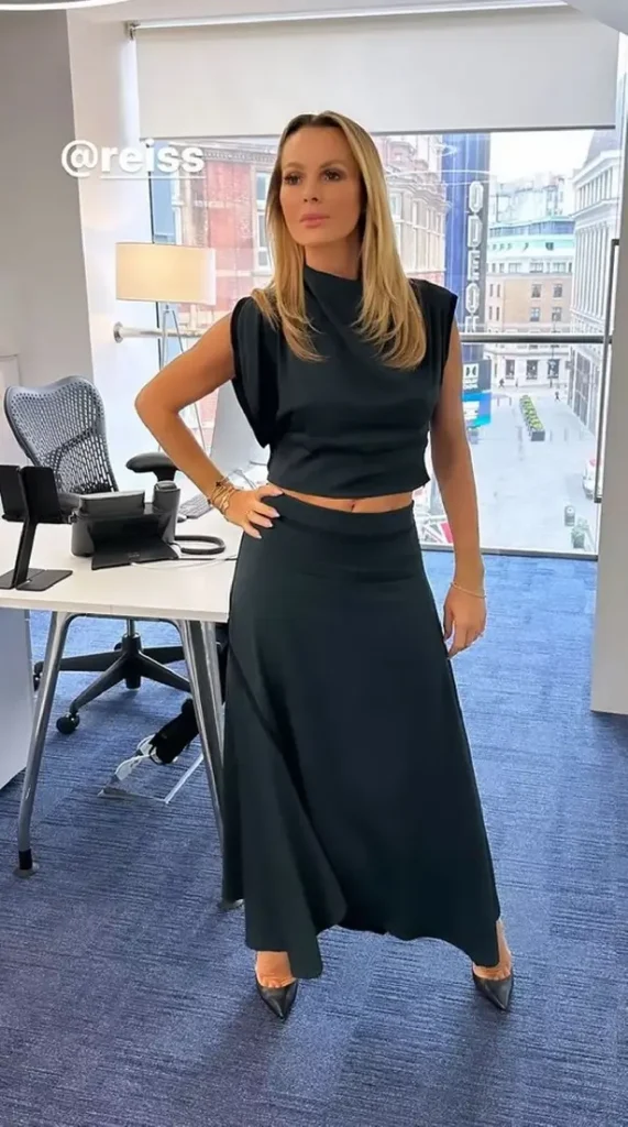 Using a backdrop of London's Leicester Square as the backdrop, Amanda twirled in her matching heels and admitted to forgetting to wear a bra underneath.