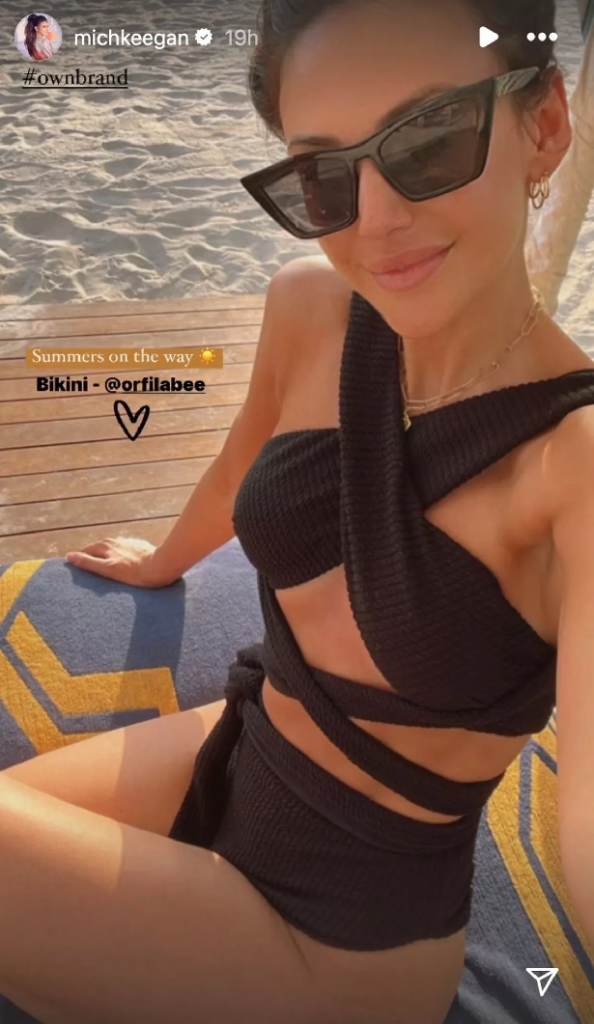 Michelle Keegan posed for a stunning selfie on the beach wearing a black bikini and halterneck top.
