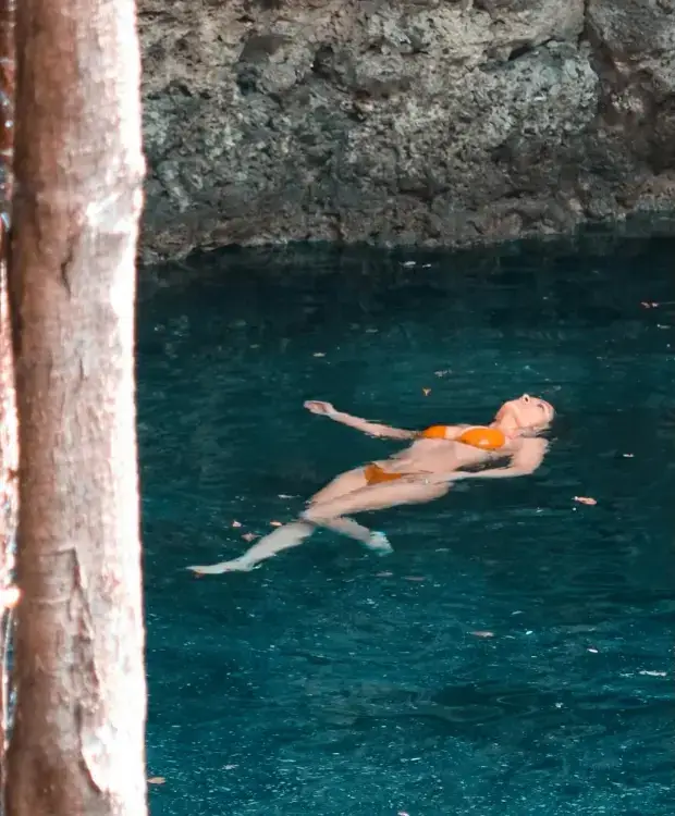 In recent bikini clad selfies, Salma Hayek boasts of her sun-kissed skin in a teeny orange bikini barely held together by string.