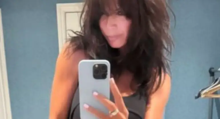 Stunning Jenny Powell flashes her toned thighs in silver knee-high boots as she poses for a sultry snap