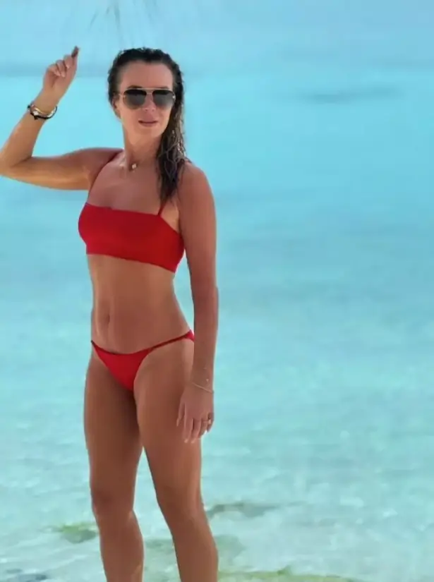 Her incredible figure was on full display during a recent family holiday abroad, when she posed in a tiny red bikini .