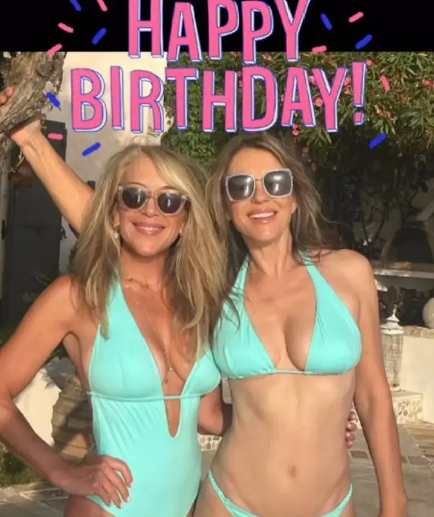 In one photo, Liz left her tummy totally exposed in a low-slung bikini, while Georgia opted for a plunging one-piece with a string belt under her bust.