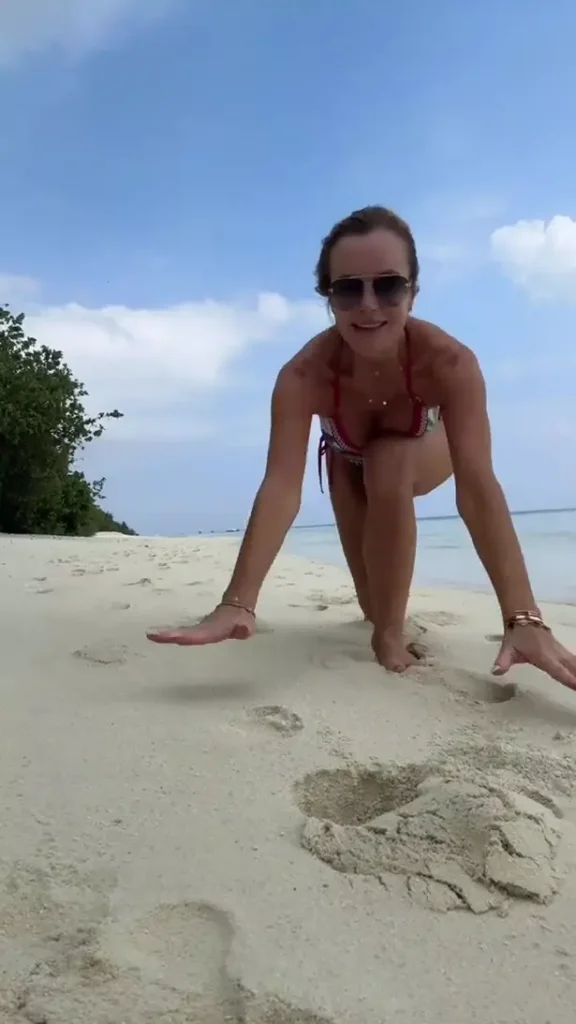 During her tropical getaway, Amanda Holden, forever a fan favorite, frolicked on a beach wearing the world's smallest bikini and left fans swooning with her famous figure.