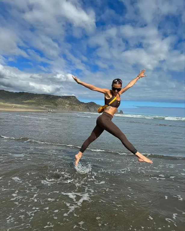 Taking advantage of the beautiful weather, Rita later donned brown leggings and a matching crop top, slung a yellow bag across her shoulders and leapt over the shallow waves wearing large shades.