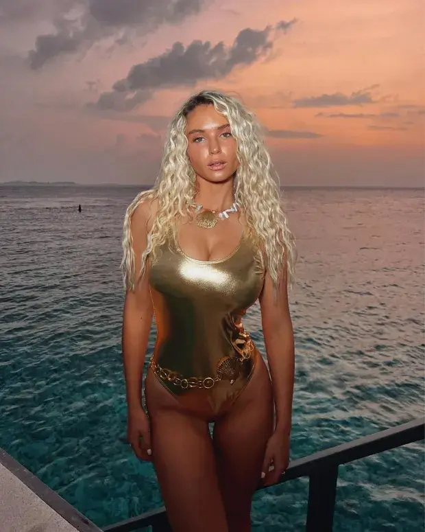 Lucie Donlan, 26, posted a stunning picture showing her in a tight gold swimsuit in front of the sea, which features an unsettling detail in the background.
