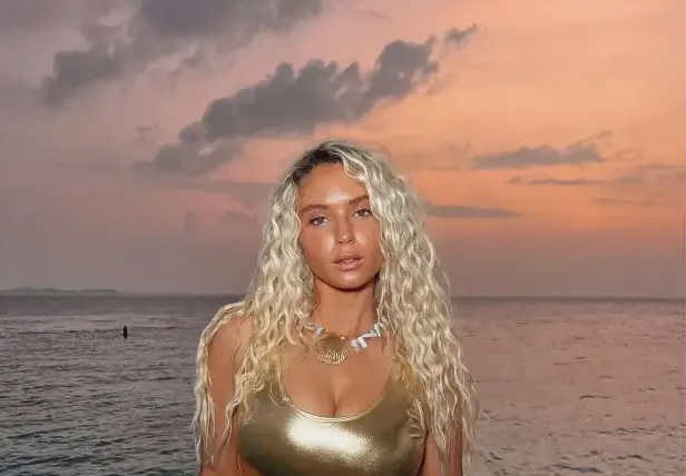Lucie Donlan shared a beautiful picture of herself in front of the sea wearing a tight gold swimsuit Lucie Donlan shared a beautiful picture of herself in front of the sea wearing a tight gold swimsuit