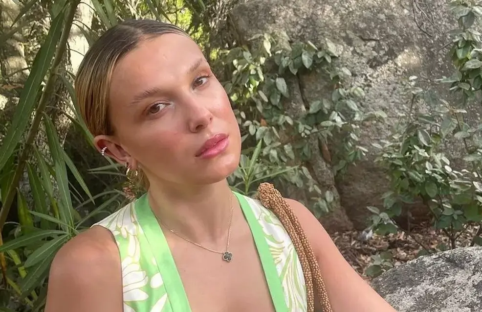 Millie Bobby Brown drew the eye to her toned shoulders and cleavage in a triangle string bikini in patterned prints