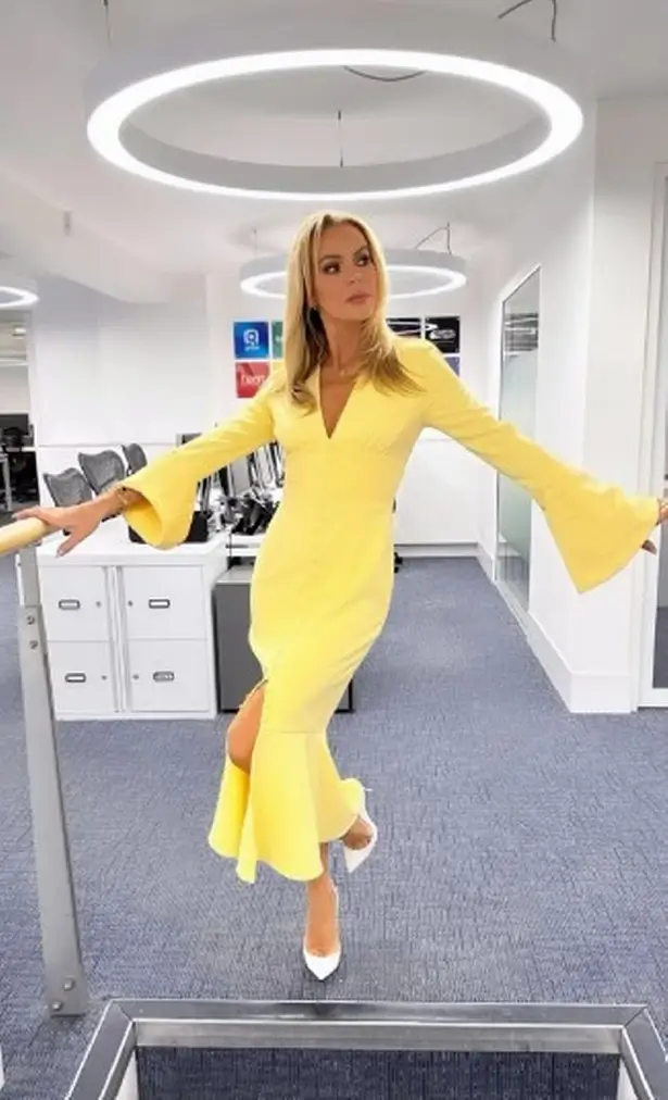 A yellow thigh-split dress showcased Amanda's effortless beauty and ageless figure as she strutted around the Heart FM offices on Thursday (May 2).